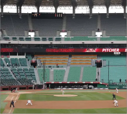  ?? PHOTOS BY LEE JIN-MAN — THE ASSOCIATED PRESS ?? Stadium seats are empty as a part of the precaution against the coronaviru­s during a baseball game Tuesday in Incheon, South Korea.