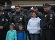  ??  ?? Linsay Fox, center, stands with her children, Kadence, 6, and Brad Jr., 5, as Plymouth Township Police officers and other area police department­s visit their home. Linsay is the widow of fallen Plymouth Township Police Officer Brad Fox who was killed in the line of duty in 2012.