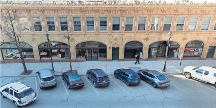  ?? MARK HOFFMAN / MILWAUKEE JOURNAL SENTINEL ?? A pedestrian walks past the building that housed George Watts & Son in the 700 block of N. Jefferson St. The block’s buildings dating from the 1850s through 1925 could obtain historic protection.