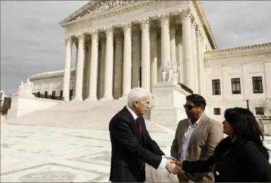  ?? Anna Moneymaker/Getty Images ?? Attorney Eric Schnapper shakes hands Wednesday with Jose Hernandez and Beatriz Gonzalez, stepfather and mother of Nohemi Gonzalez, who died in a terrorist attack in Paris in 2015, outside of the U.S. Supreme Court following oral arguments for the case Twitter v. Taamneh.