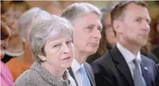  ?? — Reuters ?? Prime Minister Theresa May sits next to Chancellor of the Exchequer Philip Hammond, and Health Secretary Jeremy Hunt during an event at the Royal Free Hospital, London, on Monday.