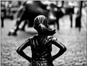  ?? JEENAH MOON/BLOOMBERG 2017 ?? State Street Global Advisors installed “Fearless Girl” in front of “Charging Bull” on Wall Street one year ago.