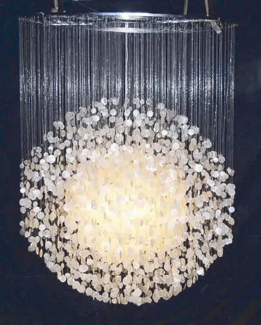  ??  ?? Shell Arts’ capiz chandelier, in black and natural color, always stops visitors in their tracks.