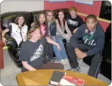  ??  ?? Charissa Taylor Lees, seated, executive director of the Solid Rock Youth Center, poses for the camera with her some of her young friends.