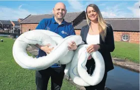  ?? ?? Canal & River Trust ecologist Louie Ramsden is delighted to accept a donated consignmen­t of pollution booms from Darcy Spillcare procuremen­t director Lauren Gower.