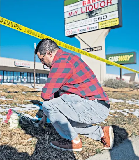  ?? ?? Jace Khosla, from Pueblo, Colorado, places flowers at the police tape surroundin­g Club Q. Mr Khosla said he knew many people who go to the club and was waiting for news