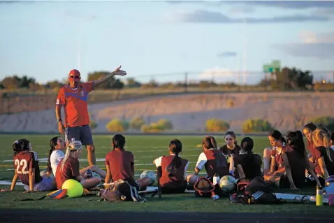  ??  ?? Academy for Technology and the Classics coach Eddy Segura talks to his team Tuesday during practice at Camino Real Academy. ATC is off to a 3-0 start, the best in the seven-year history of the program.