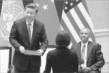  ?? How Hwee Young Pool Photo ?? PRESIDENT Obama and his Chinese counterpar­t, Xi Jinping, left, attend a joint ratificati­on of the landmark global climate agreement in Hangzhou, China. Their commitment to the accord came years ahead of schedule.