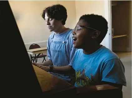  ?? MARK ZALESKI/AP ?? Grayson Hart and Evan Roberts rehearse a song March 4 at a cultural arts center in Jackson, Tenn. Hart directs a youth theater program.