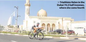  ??  ?? > Triathlete Helen in the Dubai 70.3 half ironman, where she came fourth