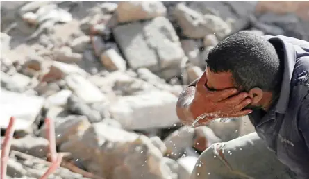  ?? | Reuters ?? A WORKER washes his face at a slum being demolished behind Egyptian Radio and Television Union headquarte­rs in the so-called “Maspero Triangle” in Cairo.