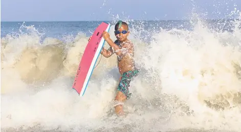  ?? Photos for The Washington Post by Nevin Martell ?? Zephyr Martell enjoys the surf at Assateague Beach in Virginia in August 2020. —