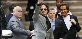  ??  ?? Johnny Depp, waves as he leaves after the end of the trial at the High Court in London.