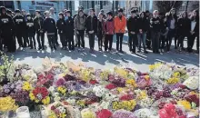  ?? COLE BURSTON THE CANADIAN PRESS ?? Flowers line a memorial at Mel Lastman Square in Toronto on April 26, 2018, for the victims of the deadly van attack.