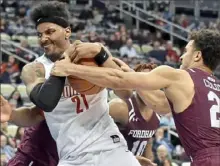  ??  ?? Michael Hughes, left, fights for a rebound against Fordham’s Josh Colon Wednesday night at PPG Paints Arena.