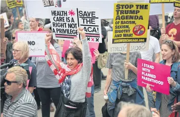  ??  ?? VICTORY: Demonstrat­ors gather near Trump Tower to celebrate the failure of Trump’s revision of the Affordable Care Act in Chicago.