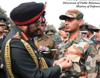  ??  ?? General Bikram Singh pinning gallantry award at special ceremony.