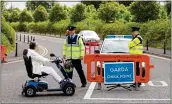  ??  ?? tight: Garda checkpoint in Knock, Co. Mayo