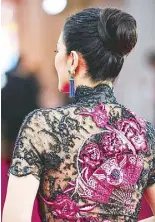  ??  ?? Detail of the Roberto Cavalli qipao of Gong Li, the actress who helped bring Chinese cinema to Europe and the US.