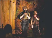  ??  ?? Brandi Lyons, left, and Jason Wuerz, a Casa Bonita cliff diver, entertain the crowd during an Old West show.