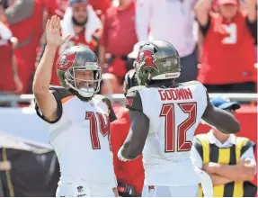  ?? KIM KLEMENT/USA TODAY SPORTS ?? Ryan Fitzpatric­k high-fives wide receiver Chris Godwin after a TD Sunday. The Bucs quarterbac­k now has eight TD passes.