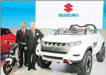  ?? (AP) ?? In this file photo, Suzuki Motor Corp President and Chairman Osama Suzuki, right, and Vice President Osamu Honda pose with a Suzuki X-Lander hybrid concept car on display at the media preview for the Tokyo Motor Show in Tokyo. Toyota, the world’s top...