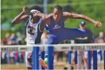  ?? STAFF PHOTO BY DOUG STRICKLAND ?? Cleveland’s Benjedi Casseus, right, pulls out ahead of Memphis Central’s Josh Owten while competing in the Class AAA 110-meter hurdles on Friday, in Murfreesbo­ro.