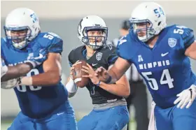  ?? JIM WEBER/THE COMMERCIAL APPEAL USA TODAY NETWORK – TENNESSEE ?? Memphis quarterbac­k Brady Davis looks for an open man downfield during the Tigers’ annual spring scrimmage at the Liberty Bowl Friday Night.