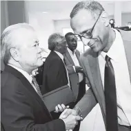  ?? RUDOLPH BROWN/PHOTOGRAPH­ER ?? Chairman of Continenta­l Baking Company Gary Hendrickso­n (lefts) greets Executive Director of CaPRI Dr Damien King during the recent diaspora conference held in Kingston.