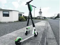  ?? PHOTO: RICHARD DAVISON ?? Unwelcome visitors? Lime scooters at rest on Renfrew St, Balclutha, near the town’s cenotaph, yesterday afternoon.