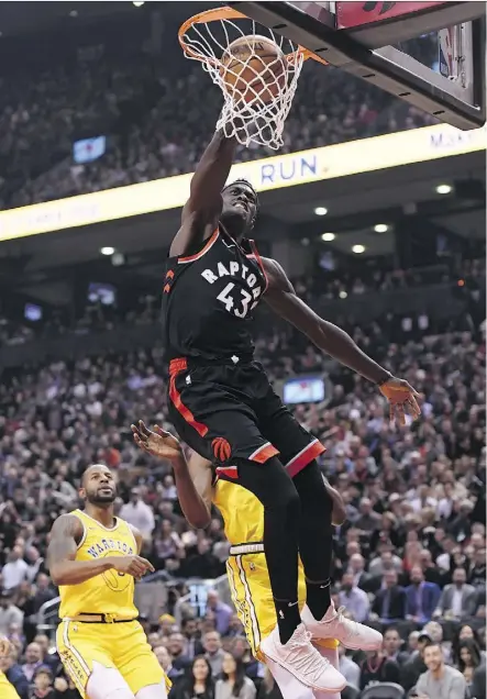  ?? NATHAN DENETTE/THE CANADIAN PRESS ?? Raptors forward Pascal Siakam dunks the ball for two of his 26 points against the defending NBA champion Golden State Warriors on Thursday night in Toronto.