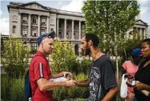  ?? Matt Rourke / Associated Press ?? Adam Bruckner with Philly Restart, left, helps Steven Kemp, who is addicted to heroin and homeless, to obtain an identifica­tion card last month in Philadelph­ia.