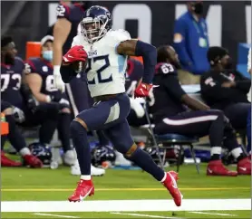  ?? Sam Craft The Associated Press ?? Titans running back Derrick Henry set the franchise record for rushing yards in a season when he ran for a career-high
250 yards in Tennessee’s 4138 win against the Houston Texans on Sunday.