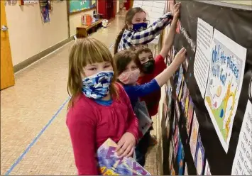  ?? Courtesy of Long Lake Central School District ?? First graders at Long Lake Central School District add stickers to a bulletin board. The small and rural Long Lake and Indian Lake school districts did not qualify for COVID-19 relief from the American Rescue Plan.