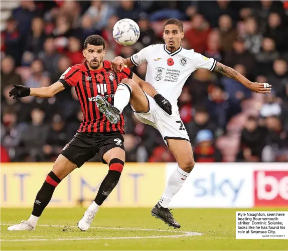  ?? GARETH EVERETT ?? Kyle Naughton, seen here beating Bournemout­h striker Dominic Solanke, looks like he has found his role at Swansea City.