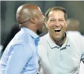  ?? / LEFTY SHIVAMBU ?? Roger De Sa shares a light moment with Platinum Stars general manager Senzo Mazingiza.