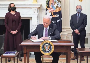  ?? AFP VIA GETTY IMAGES ?? President Joe Biden, Vice President Kamala Harris and Chief Medical Adviser Anthony Fauci address the coronaviru­s pandemic on Thursday at the White House.