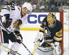  ??  ?? Marc-Andre Fleury makes a save on Chicago right winger Marian Hossa on Wednesday night at PPG Paints Arena.