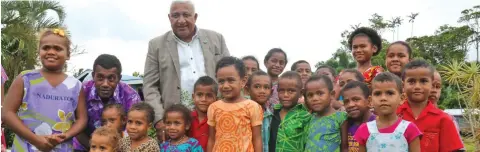  ?? Photo: Kelera Sovasiga ?? Prime Minister Voreqe Bainimaram­a with children and villagers of Dravuni during the commission­ing of the seawall on June 12, 2020.