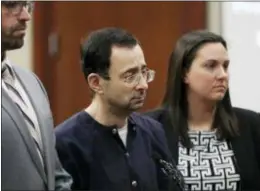  ?? CARLOS OSORIO — THE ASSOCIATED PRESS ?? Larry Nassar walks to the podium with attorneys Matt Newburg, left, and, Shannon Smith during his sentencing hearing Wednesday in Lansing, Mich. The former sports doctor who admitted molesting some of the nation’s top gymnasts for years was sentenced...