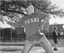  ?? JONATHAN ZIZZO/NEW YORK TIMES ?? Frank Miller pitches with strangers after a callout on social media for a game of catch Wednesday in Dallas. The callout drew a varied group of people who found escape from society’s turbulence in the most banal ritual.