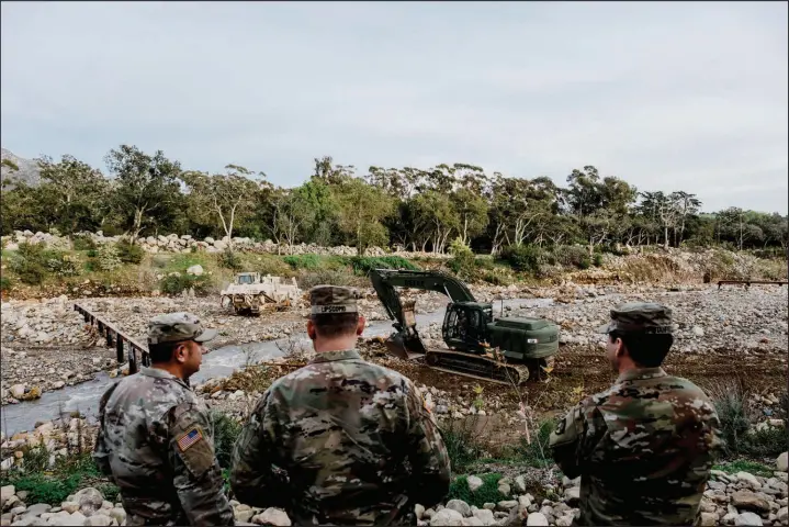  ?? MARK ABRAMSON / THE NEW YORK TIMES ?? Members of the 649th Engineerin­g Company of the California National Guard work at the Randall Road Debris Basin to clear flood rubble Jan. 12 in Montecito, Calif. Life in California often requires navigating the edge of disaster and natural beauty. On the fifth anniversar­y of a catastroph­e, Montecito residents had to flee again.