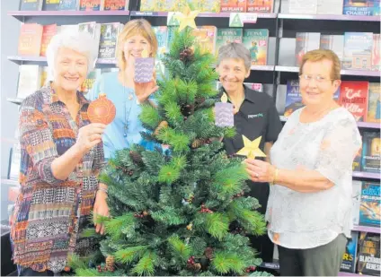  ?? Photo / Ilona Hanne ?? From left, Raewyn, Rose, Margie and Judy with some of the decoration­s people can place on the tree along with a special message.