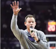  ?? Paul Connors / Associated Press ?? UConn football coach Jim Mora addresses the Gampel Pavilion crowd during a men’s basketball game on Wednesday.