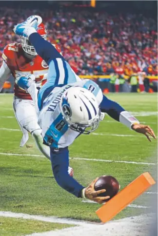  ?? Dilip Vishwanat, Getty Images ?? Titans quarterbac­k Marcus Mariota dives for the end zone to score a touchdown Saturday, a result of catching his own pass that had been batted back to him.
