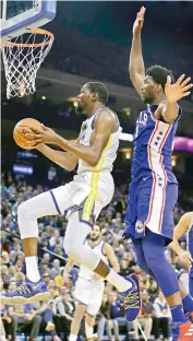  ?? AP ?? Golden State Warriors’ Kevin Durant (left) lays up a shot past Philadelph­ia 76ers’ Joel Embiid during their NBA basketball game on Saturday in Oakland, California. —