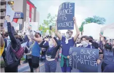  ?? ADOLPHE PIERRE-LOUIS/JOURNAL ?? Protesters block streets in Downtown Albuquerqu­e last Sunday in response to the killing of George Floyd in Minneapoli­s.