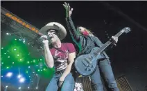  ?? RICHARD BRIAN/ LAS VEGAS REVIEW-JOURNAL @VEGASPHOTO­GRAPH ?? Country music artist Dustin Lynch, left, and a guitarist perform for fans at the 2016 Route 91 Harvest country music festival at the Las Vegas Village.