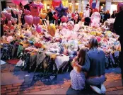  ?? PICTURE: REUTERS ?? People attend a vigil yesterday in central Manchester for the victims of last week’s attack at a pop concert at Manchester Arena.