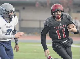  ?? Jenn March / Special to the Times Union ?? Glens Falls QB Joe Girard III sprints past Cobleskill’s Justin Schrom in the Class B Super Bowl on Saturday. Glens Falls rushed for 304 yards.